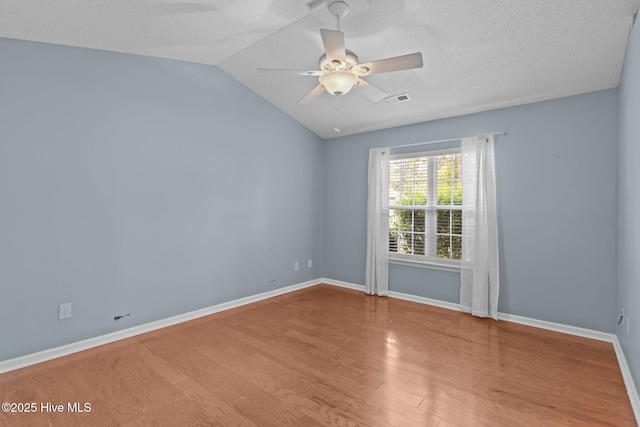808 Tanlaw Ct, Wilmington, NC 28412 - empty room with wood finished floors, a ceiling fan, vaulted ceiling, and a textured ceiling