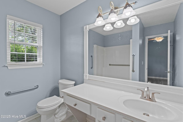 full bathroom with vanity, baseboards, and toilet