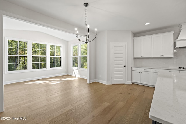 231 Dona Dr, Carthage, NC 28327 - unfurnished dining area with a chandelier, baseboards, light wood-style flooring, recessed lighting, and vaulted ceiling