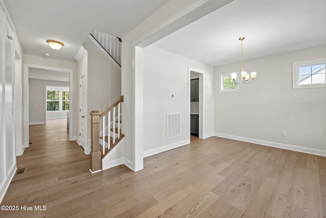 231 Dona Dr, Carthage, NC 28327 - unfurnished dining area with a chandelier, light wood-type flooring, healthy amount of natural light, and stairs