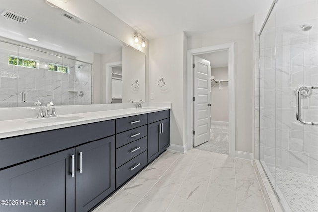 231 Dona Dr, Carthage, NC 28327 - bathroom featuring a stall shower, a walk in closet, double vanity, and marble look tile flooring