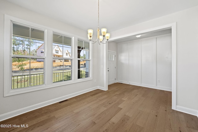 231 Dona Dr, Carthage, NC 28327 - unfurnished dining area featuring wood finished floors, a chandelier, and baseboards