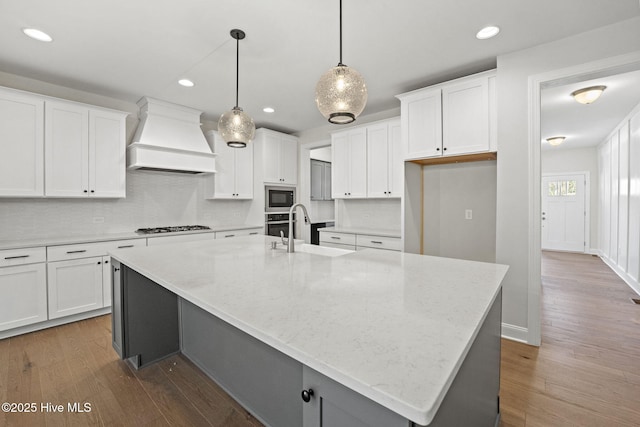 231 Dona Dr, Carthage, NC 28327 - kitchen featuring custom range hood, a sink, built in microwave, gas stovetop, and a large island