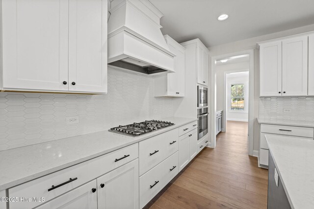 231 Dona Dr, Carthage, NC 28327 - kitchen featuring stainless steel appliances, premium range hood, tasteful backsplash, white cabinets, and recessed lighting