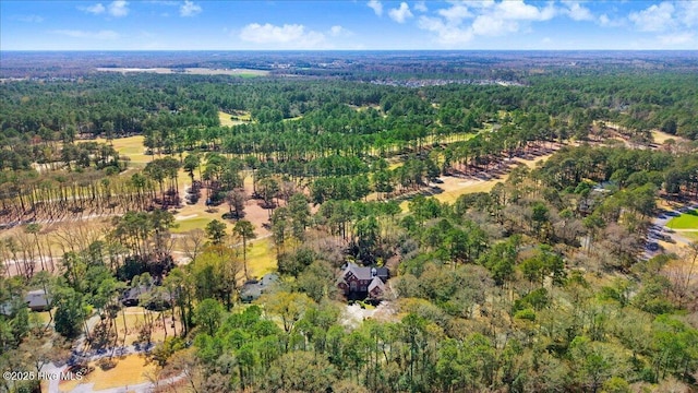 drone / aerial view with a wooded view