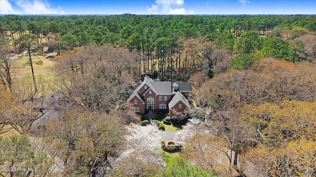 birds eye view of property featuring a view of trees