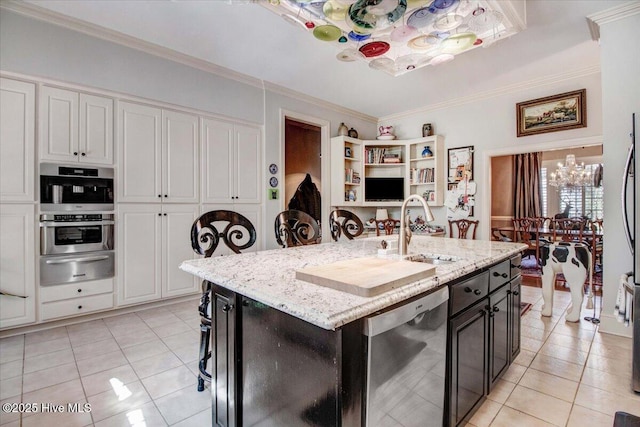 kitchen featuring stainless steel dishwasher, light tile patterned flooring, white cabinets, a sink, and a warming drawer