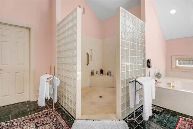 full bathroom featuring a bath, visible vents, a walk in shower, tile patterned floors, and lofted ceiling