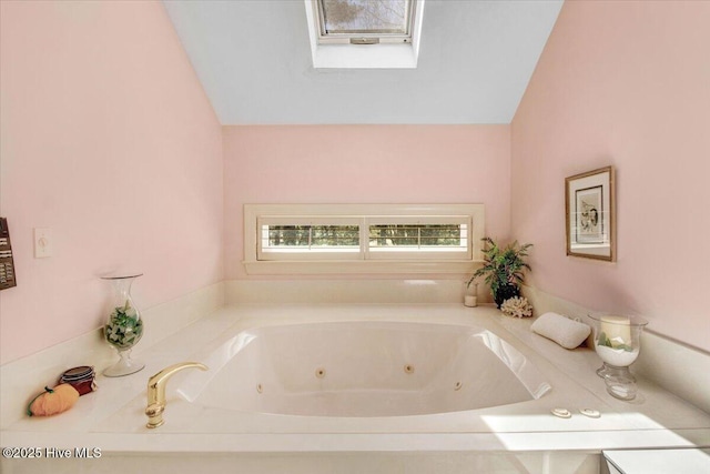 full bath with a jetted tub and lofted ceiling