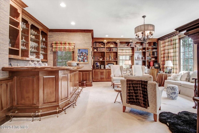 interior space with ornamental molding, built in features, light colored carpet, recessed lighting, and a notable chandelier