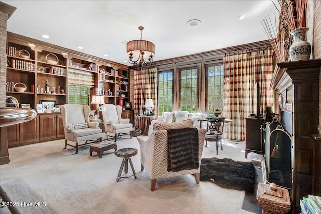 sitting room featuring crown molding, recessed lighting, a notable chandelier, and light carpet