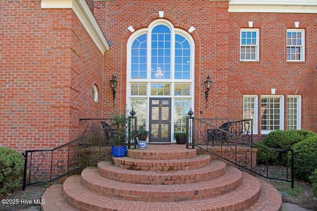property entrance with french doors and brick siding
