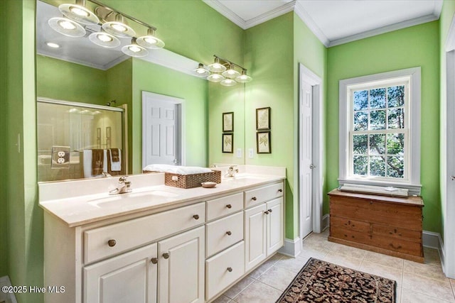 bathroom with double vanity, crown molding, a shower stall, a sink, and tile patterned floors