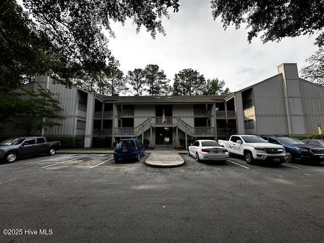 6214 Harbourside Dr, New Bern, NC 28560 - view of building exterior featuring uncovered parking and stairs