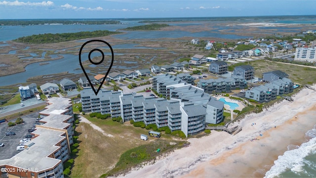 bird's eye view featuring a view of the beach and a water view