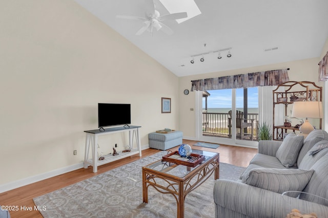 living area featuring baseboards, a ceiling fan, wood finished floors, and visible vents