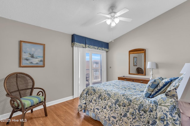 bedroom with access to exterior, a ceiling fan, baseboards, light wood-type flooring, and vaulted ceiling