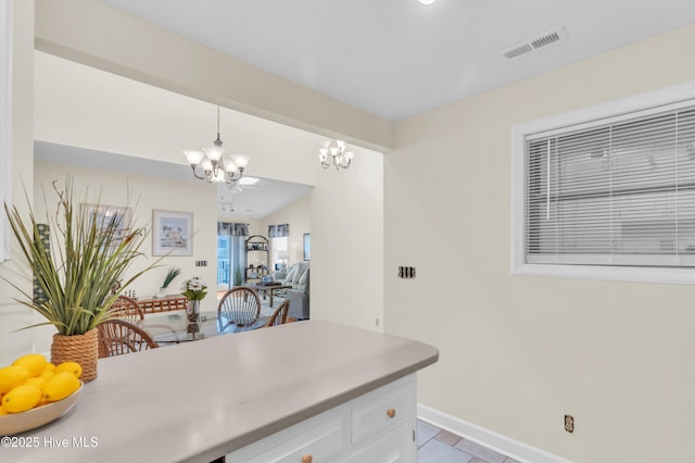 1896 New River Inlet Rd Unit 1402, North Topsail Beach, NC 28460 - kitchen featuring a chandelier, white cabinets, hanging light fixtures, light countertops, and light tile patterned floors