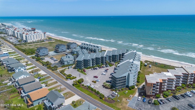 birds eye view of property with a water view and a view of the beach
