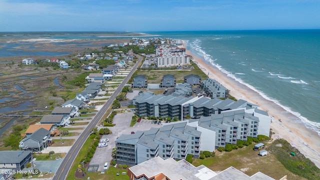birds eye view of property with a beach view and a water view