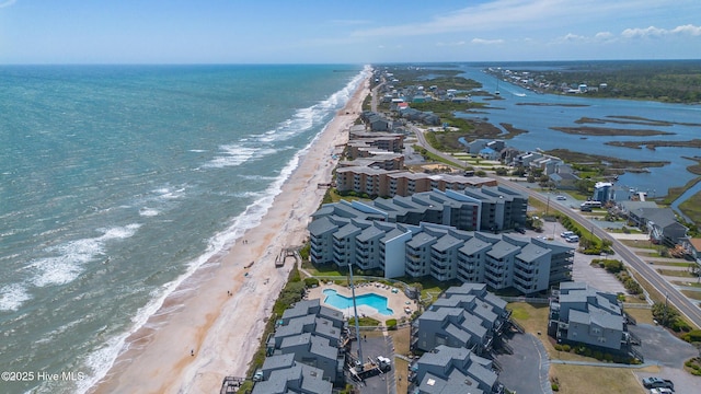 aerial view with a water view and a beach view