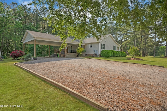 view of front of property featuring covered porch, crawl space, driveway, and a front yard