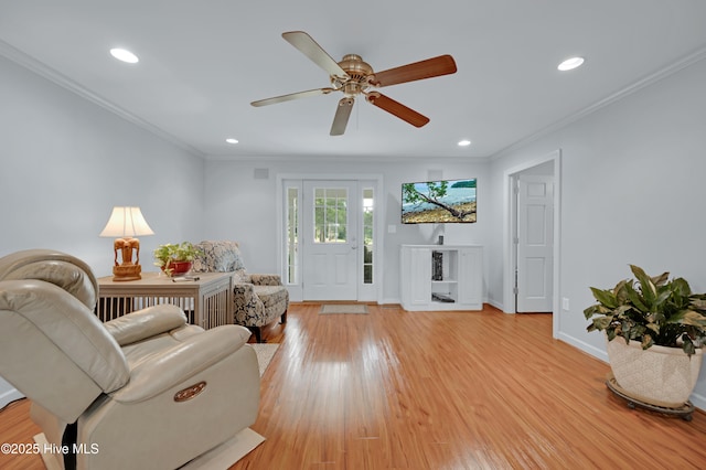 living area featuring crown molding, baseboards, light wood-style floors, and recessed lighting