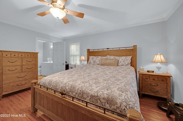 bedroom with crown molding, ceiling fan, wood finished floors, and connected bathroom