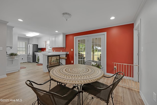 dining room featuring baseboards, ornamental molding, recessed lighting, and light wood-type flooring