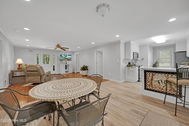 dining area with recessed lighting, ornamental molding, and a healthy amount of sunlight