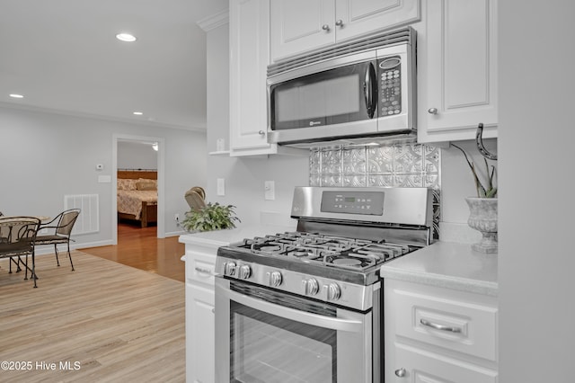 kitchen featuring visible vents, light countertops, appliances with stainless steel finishes, and white cabinets
