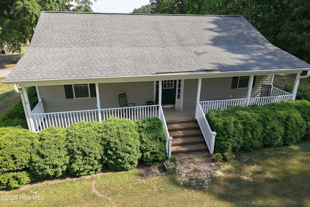 country-style home with a porch, roof with shingles, and stairway