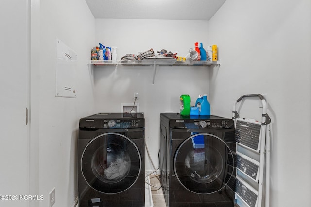 clothes washing area featuring separate washer and dryer and laundry area