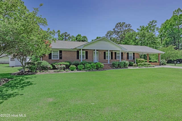 single story home featuring covered porch, an attached carport, a front lawn, and brick siding