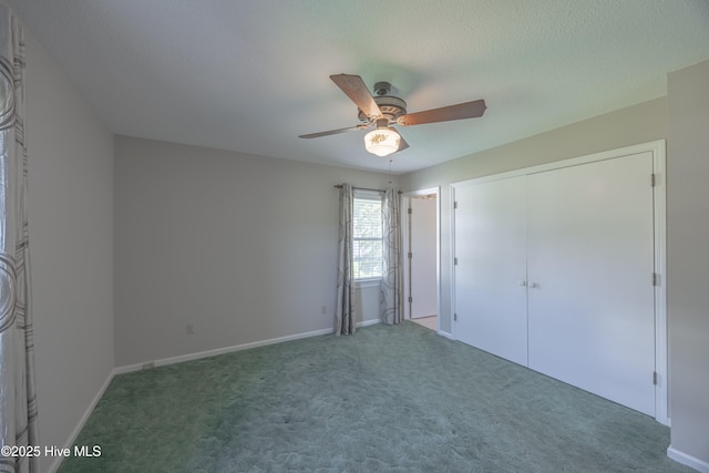 unfurnished bedroom with carpet floors, ceiling fan, and baseboards