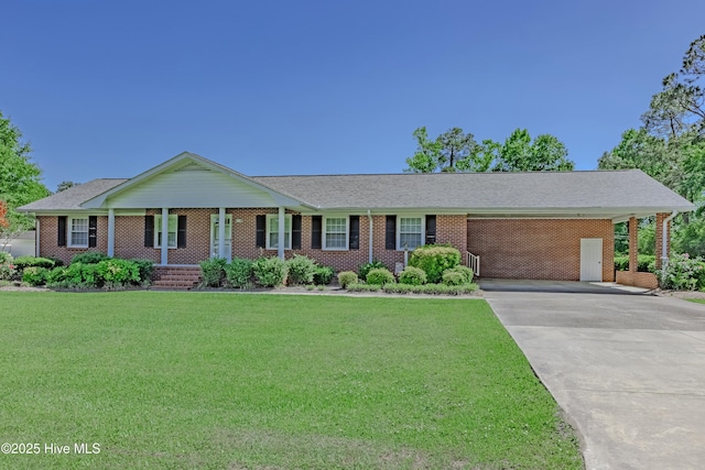 ranch-style home with a porch, a carport, a front yard, and concrete driveway