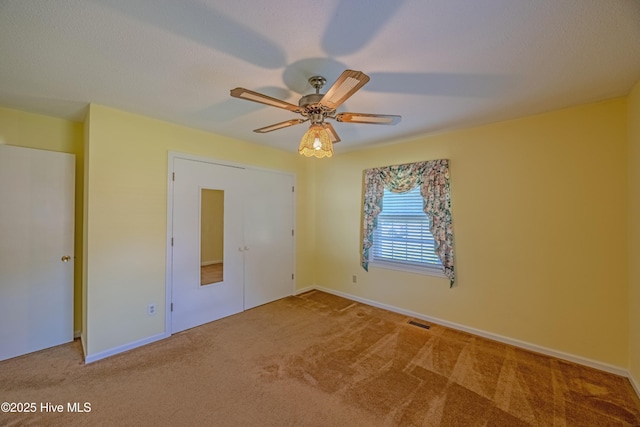 unfurnished bedroom with baseboards, carpet flooring, and visible vents