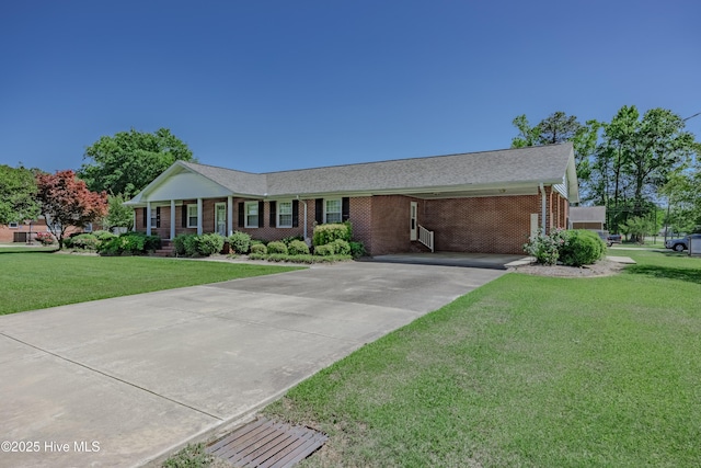 ranch-style home featuring brick siding, driveway, and a front yard