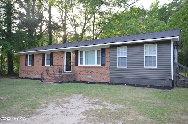 ranch-style home with brick siding, crawl space, and a front lawn