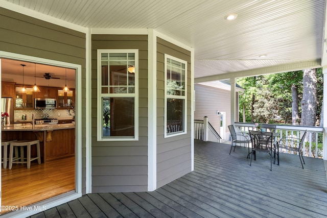 wooden deck featuring outdoor dining area