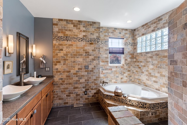 full bathroom featuring tile walls, a garden tub, double vanity, recessed lighting, and tile patterned flooring