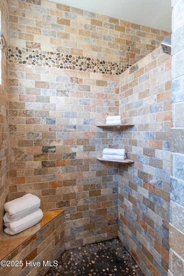 bathroom with a tile shower
