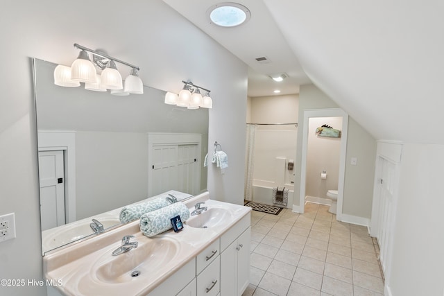 bathroom featuring toilet, lofted ceiling, double vanity, tile patterned flooring, and tub / shower combination