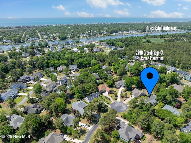aerial view of residential area with a nearby body of water