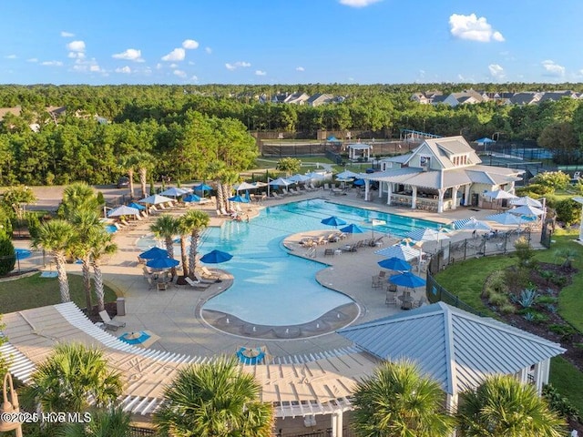 community pool featuring a patio area and fence