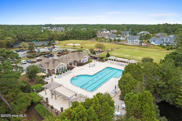 aerial view of residential area with a pool and a local golf course