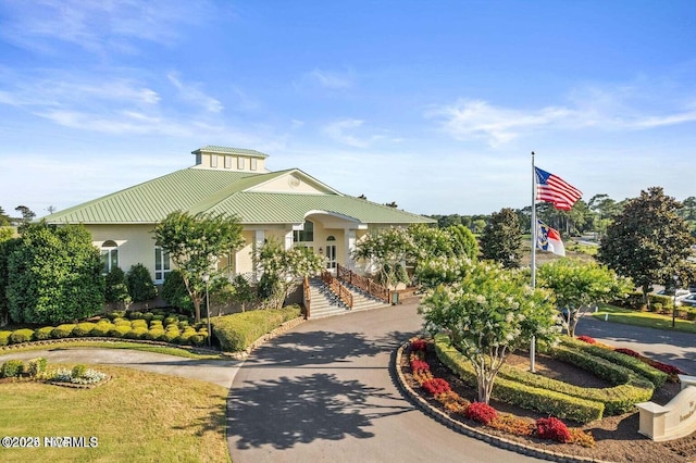 view of property's community featuring curved driveway and stairway