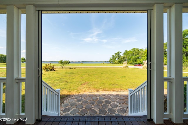 exterior space featuring a water view, plenty of natural light, and wood finished floors