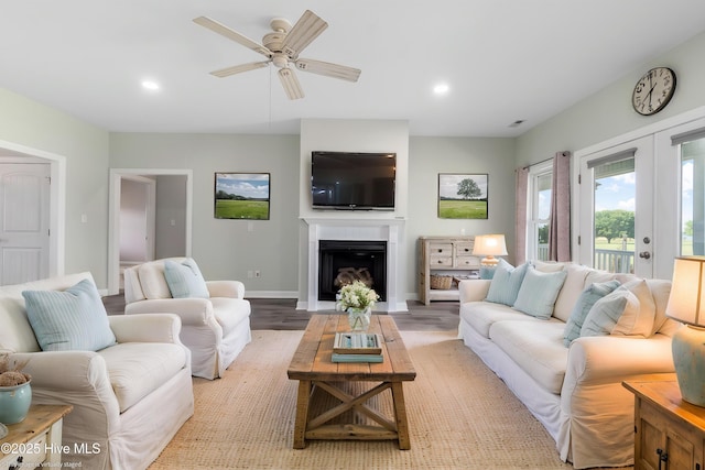 living area with recessed lighting, ceiling fan, baseboards, and light wood-style floors