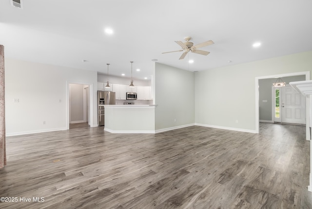 unfurnished living room with recessed lighting, a ceiling fan, baseboards, and wood finished floors